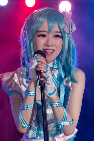 Japanese cosplayer Ria Kurumi sings on music stage while getting fucked from behind